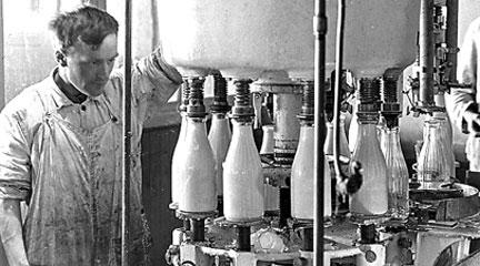 Photo, Two men fill milk bottles at a creamery, 1920, New York State Archives