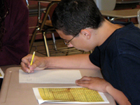 A student completing an in-class writing assignment. NHEC