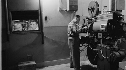 film negative, Man working with a projector in a movie theater, 1958 Feb. 9, Mar