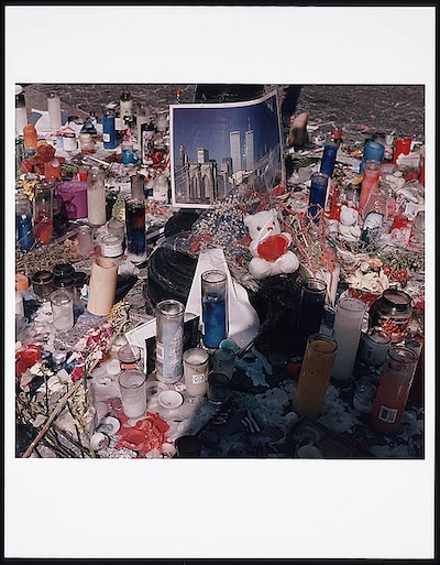 Candles, stuffed animals, photographs, and flowers gathered together to memorialize 9-11 victims