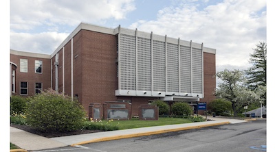 Large three story square brick building.