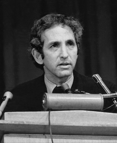 Ellsberg at the time of the Pentagon Papers case sitting in front of 3 microphones