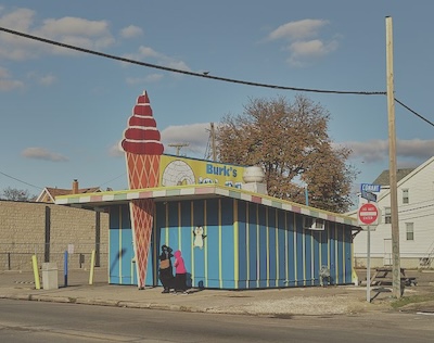 Ice cream stand decorated with a large ice cream cone. 