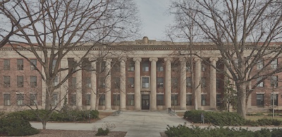 Wide building with a dozen tall concrete columns at the front.