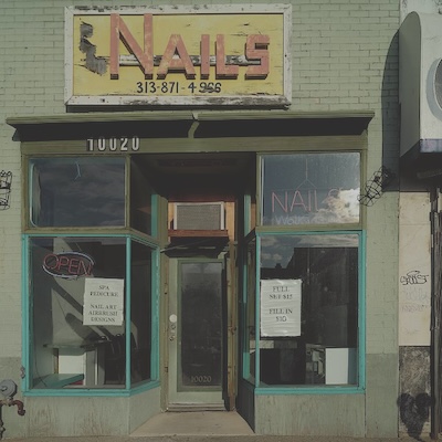 Small store front with a sign above the door reading Nails.