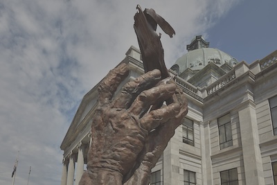 Sculpture of two hands holding another item