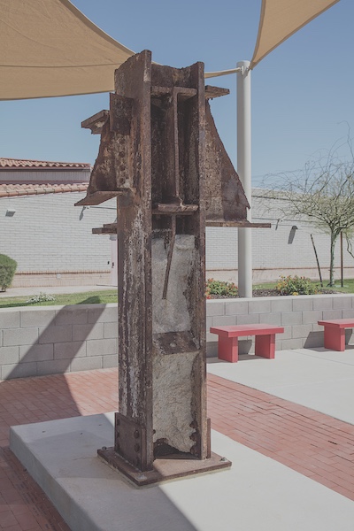 A rusted section of steel beam sits on a display. The steel beam was recovered from the Twin Towers after they fell.