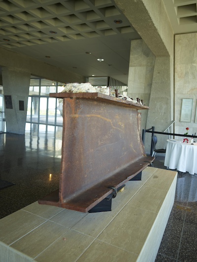 A rusted section of steel beam sits on a display. The steel beam was recovered from the Twin Towers after they fell.