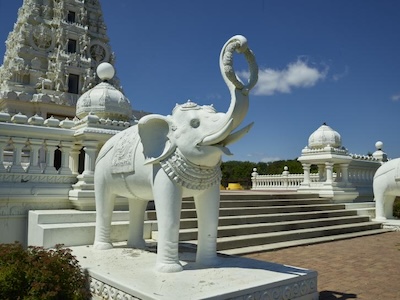 Elephant sculpture in front of temple.