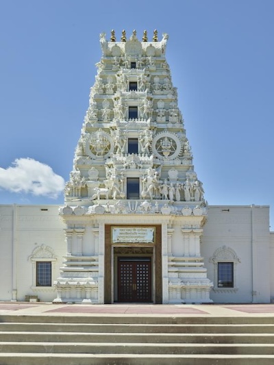 An ornate white building with carved designs and figures.