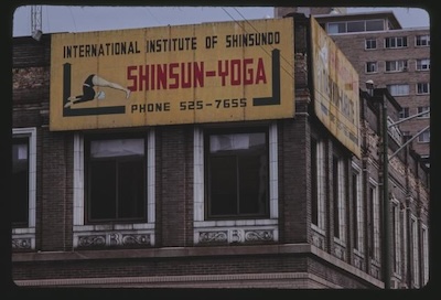 Building with an International Institute of Shinsundo Shinsun Yoga sign with image of a person doing yoga.