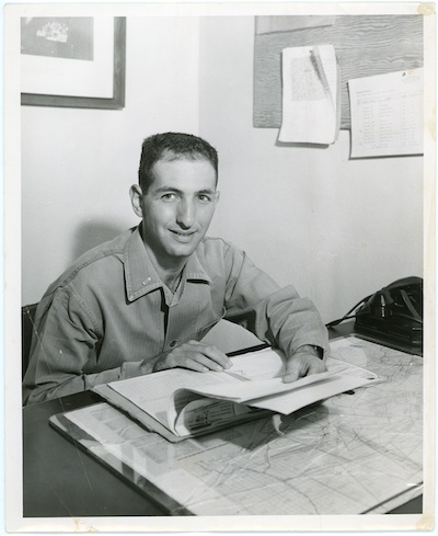 Ellsberg in the Marines in the 1950s. Sitting at a desk looking over papers