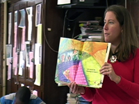 An eigth grade teacher reading a childrens book to her class. NHEC
