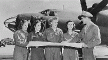 Photograph, Four members of the United States Women's Airforce Service Pilots (WASPs) receive final instructions as they chart a cross-country course on the flight lines of U.S. airport, 1942-1945, Records of the Office of War Information. Photo, 4 of the US WASPs.., 1942-1945, Records of the Office of War Information.
