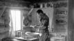 Photo, L. Lindsley in cabin kitchen baking bread, ca. 1910, Lawrence D. Lindsley