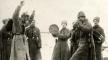 Photo, The Great War. First World War, Russian army. The Russians teaching the German prisoners of war the cossack dance. The Eastern front, Russia, 1915, Nationaal Archief, Flickr Commons Photo, Russians teaching prisoners the cossack dance., 1915, Flickr Commons