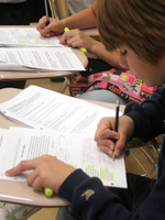 A middle school student completing a writing assignment. NHEC
