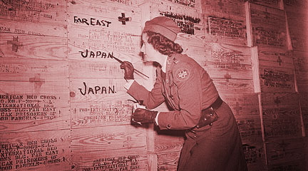 Red Cross volunteer labels packages destined for POWs in Japan