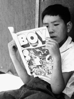 Photo, A boy reads a comic book, Dorothea Lange, 1942, Ease History