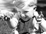 Photo, A small boy with chicks on a farm. . . , 1932, New York State Archives